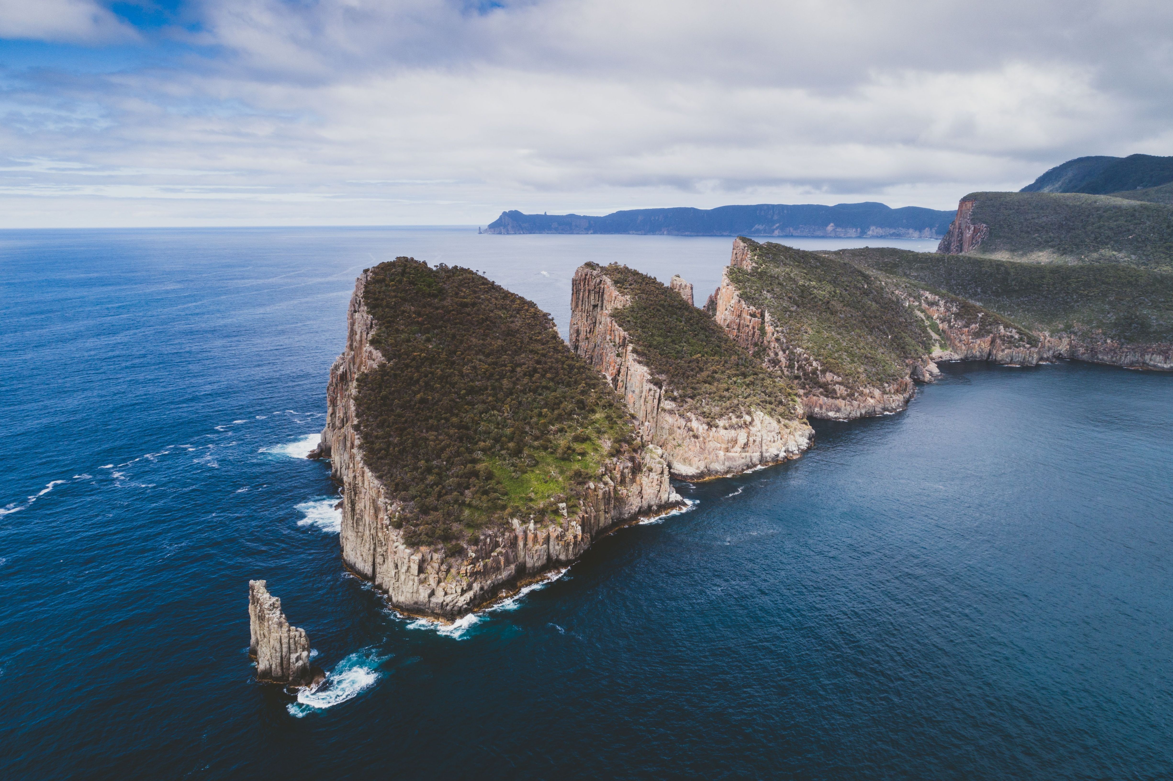 Aerial view of towering sea cliffs and a rock spire at Cape Hauy, Tasman National Park