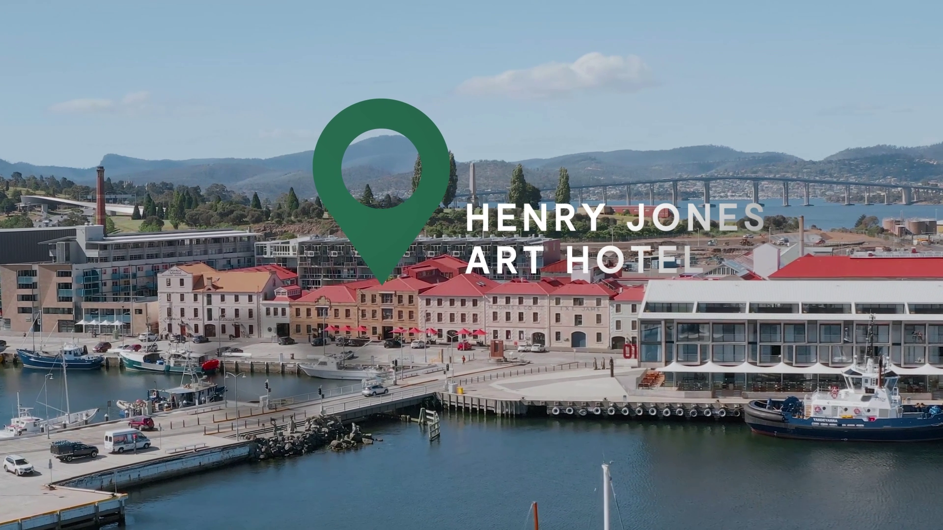 Henry Jones Art Hotel video still with a location pin over an aerial of the Hobart waterfront