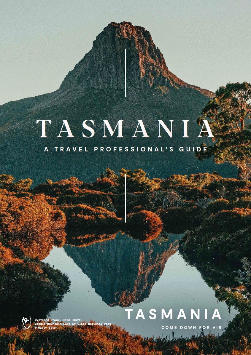 A Travel Professional's Guide cover, over Barn Bluff reflected in a tarn on the Overland Track